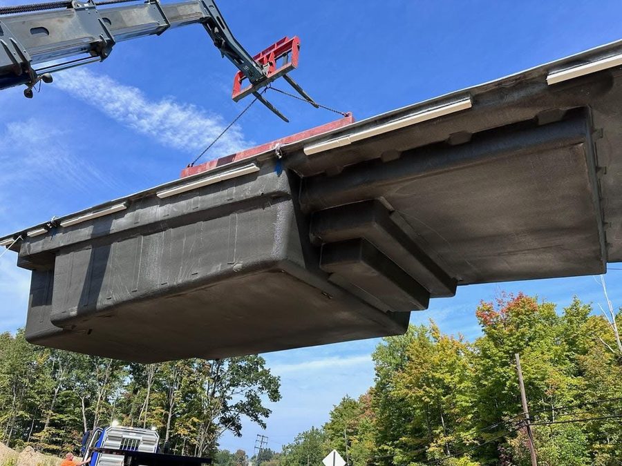 Fiberglass shell lifted by crane into place