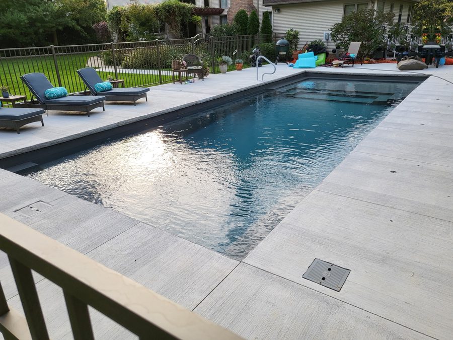 Residential pool with loungers and a clean deck