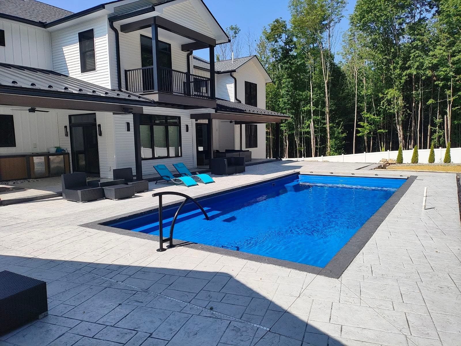 Modern pool installed behind a white contemporary home