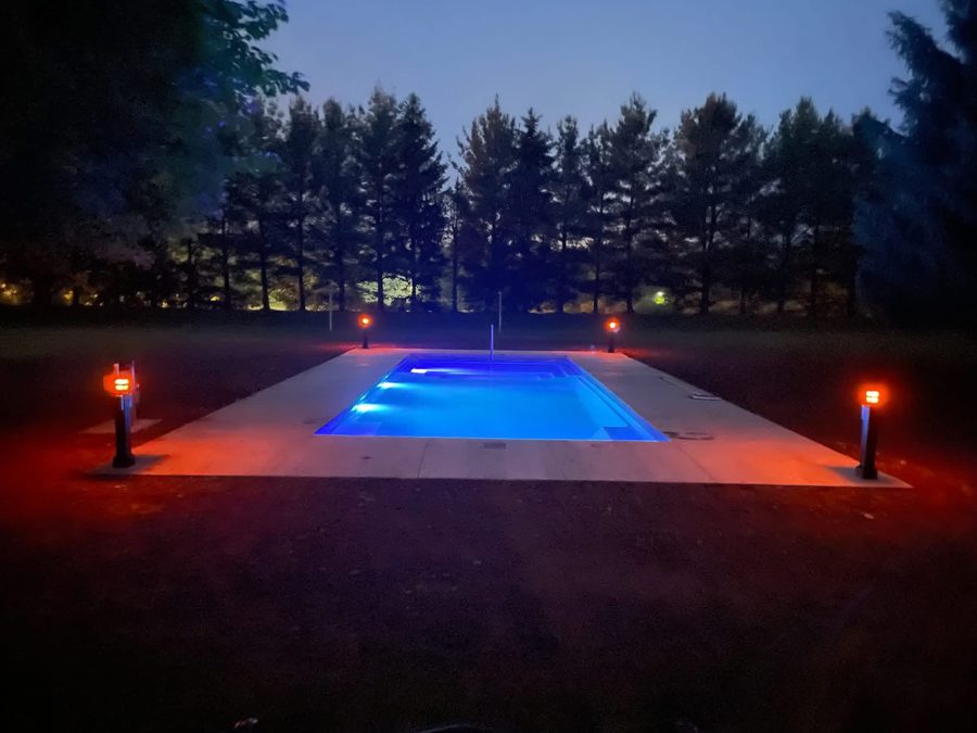 Pool glowing blue at dusk with LED lighting